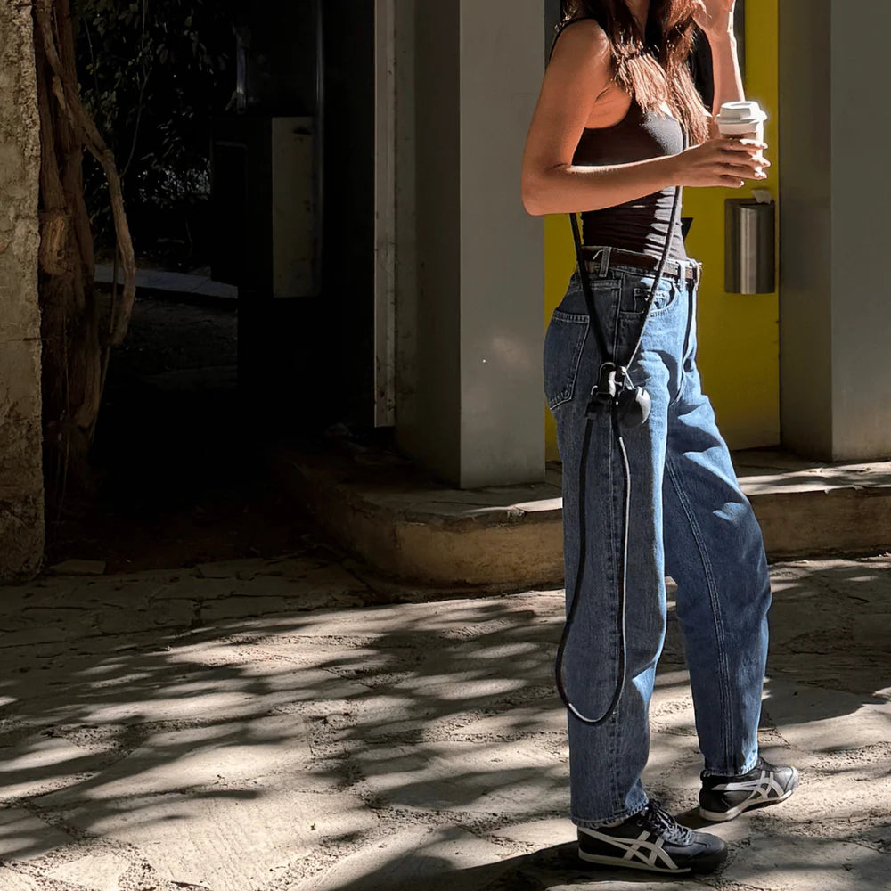 Dog owner using hands-free dog lead cross-body style, practical and comfortable walking accessory