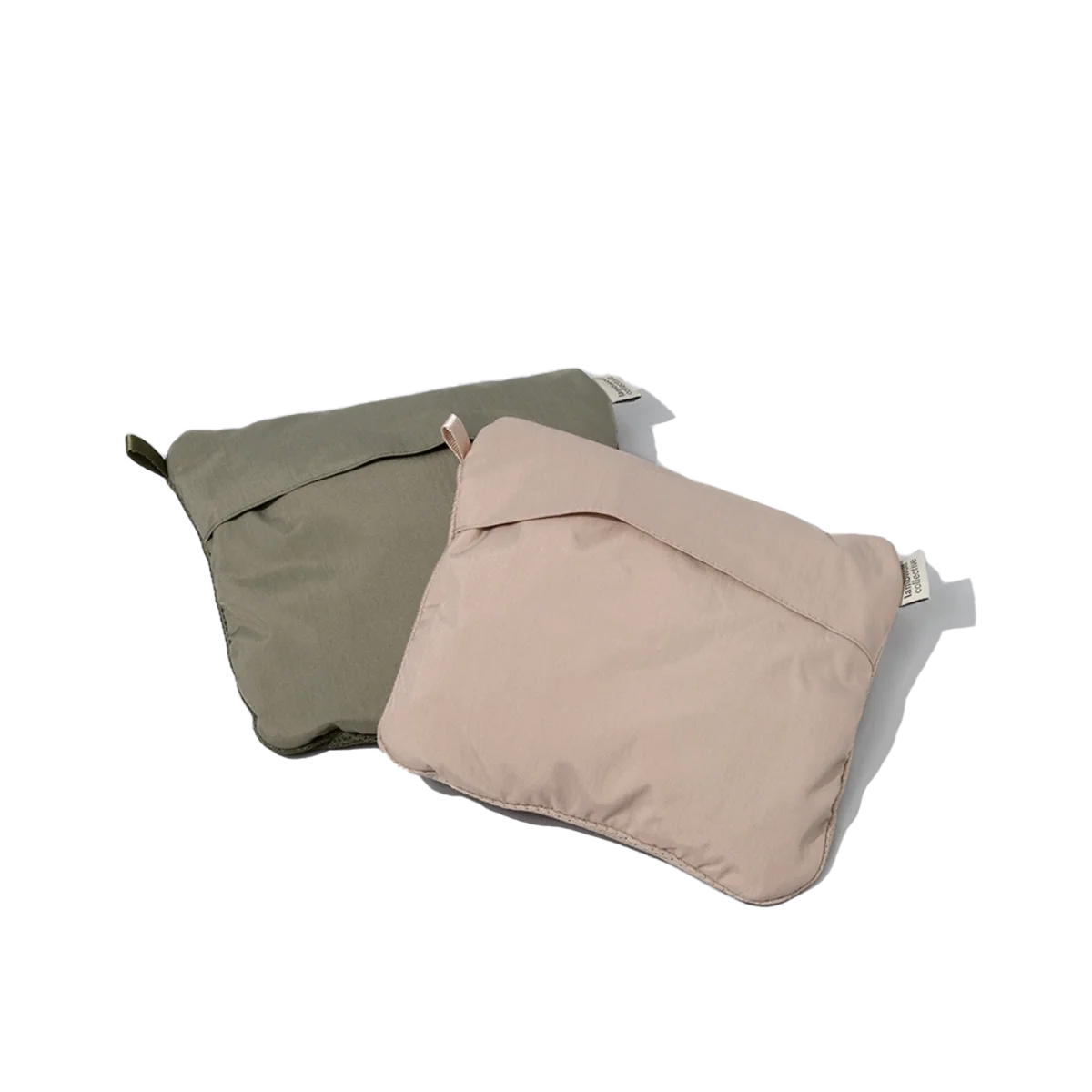 folded Lambwolf Collective waterproof dog raincoats in sage green, functional and stylish outerwear