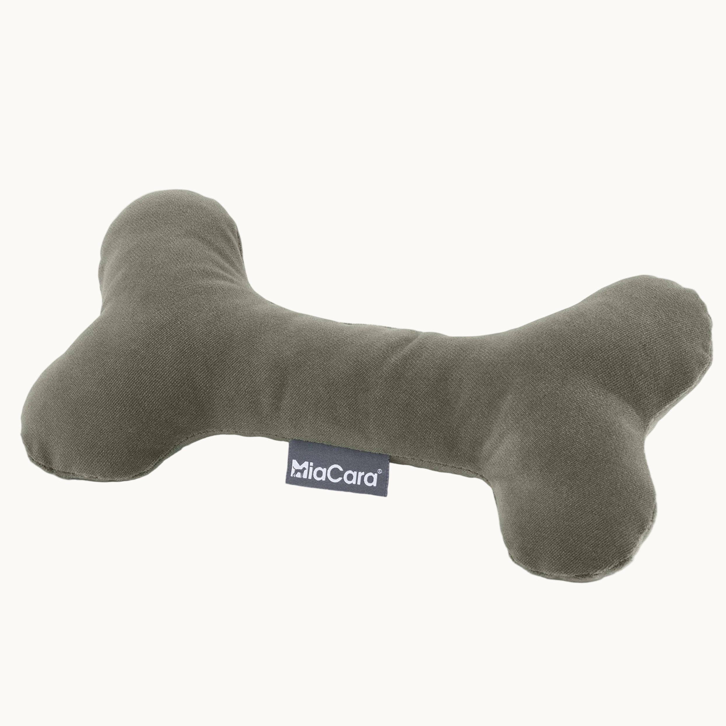 Close-up of MiaCara grey plush toy bone, soft fabric with stitched MiaCara label