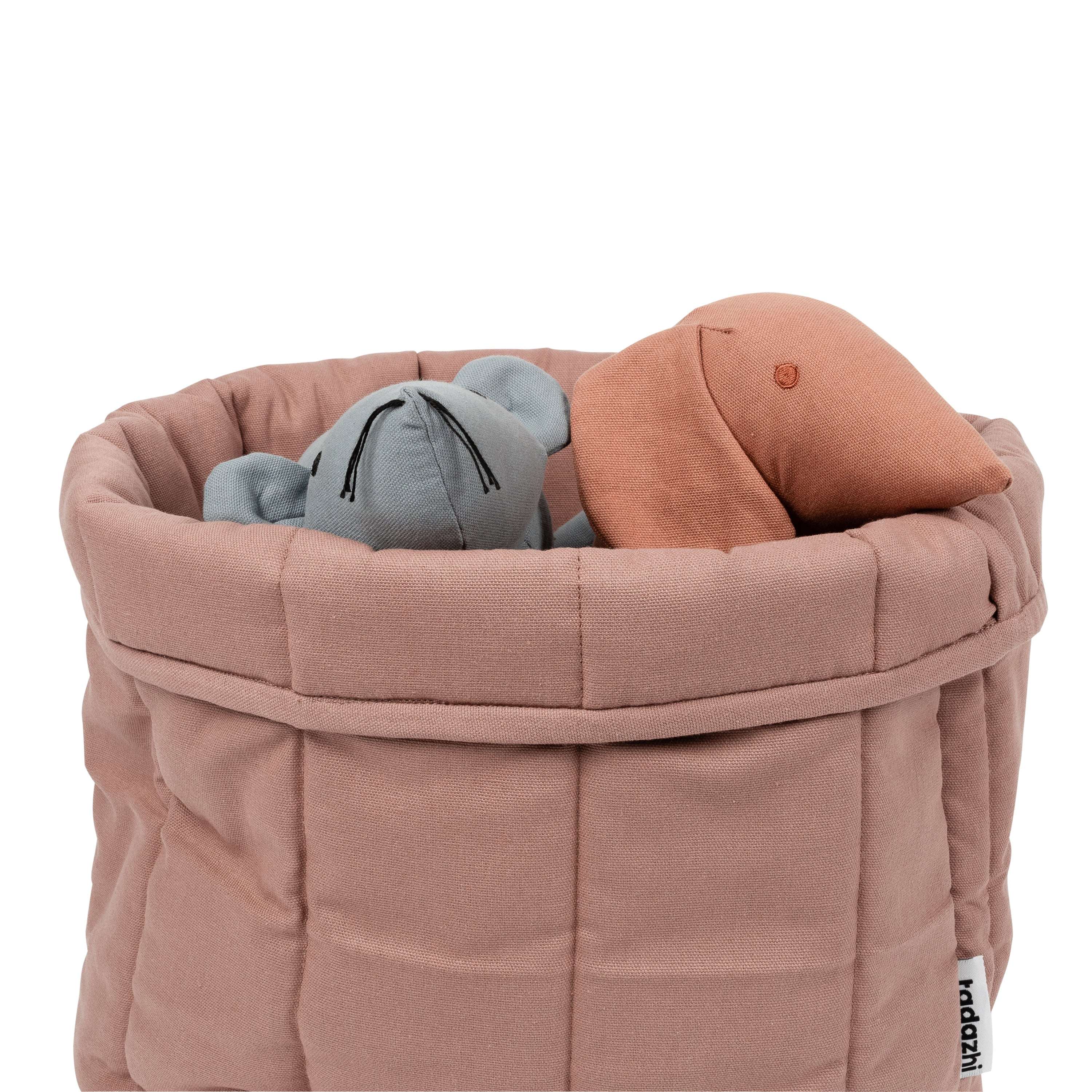 Scandanavian style pet storage basket in pink filled with toys