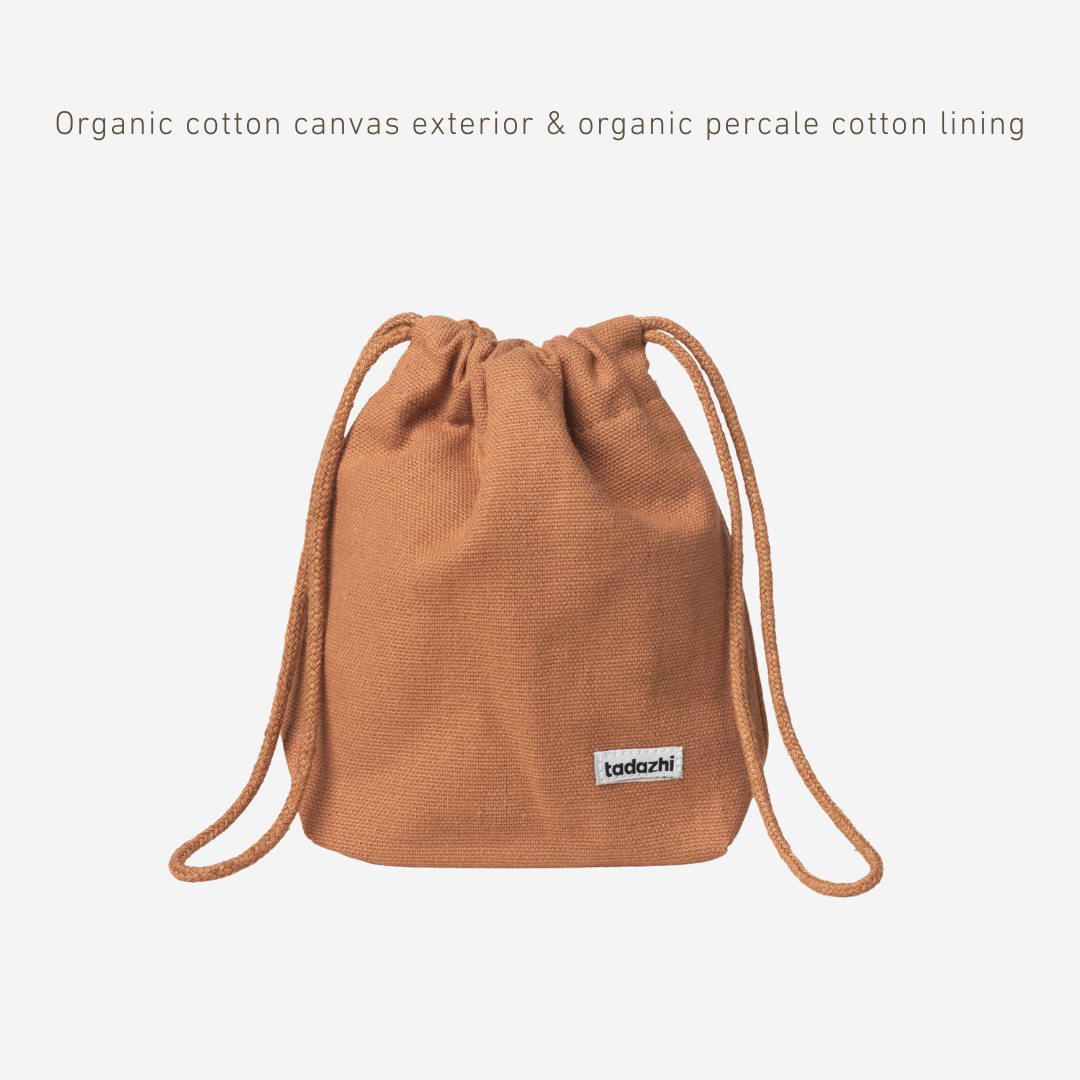 Brown drawstring bag with organic cotton canvas exterior and percale cotton lining on a white background.