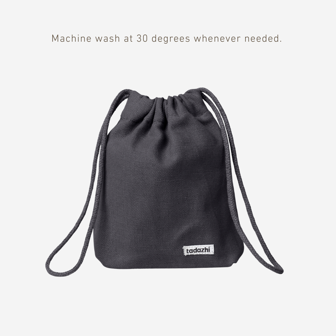Black drawstring bag with tadzio label on a white background