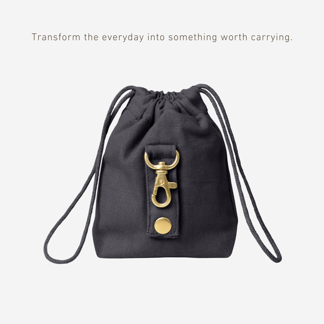 Black drawstring bag with gold accents on a white background
