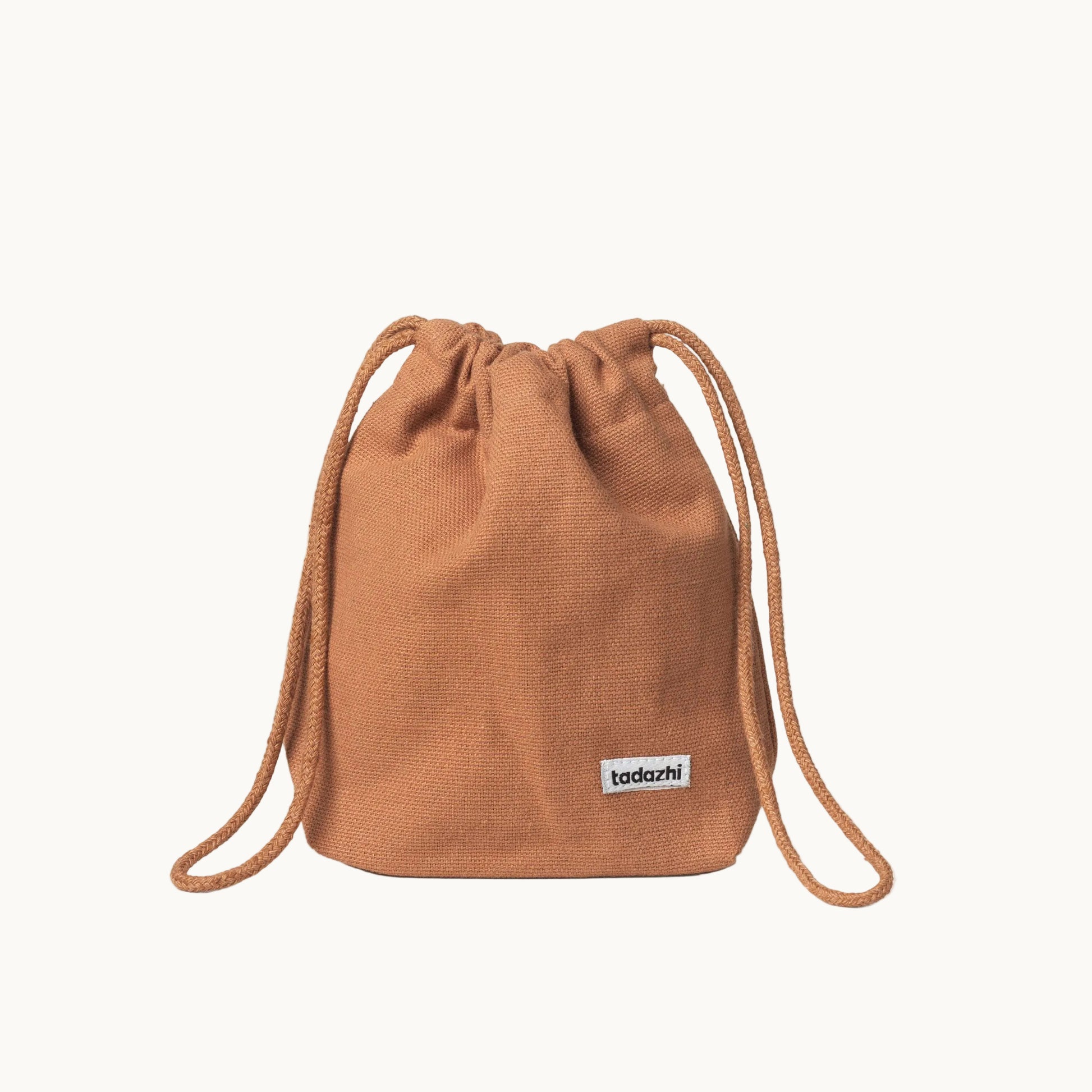 Minimalist dog treat bag in orange fabric with drawstring closure, part of Tadazhi x Lumi Pets Walk collection