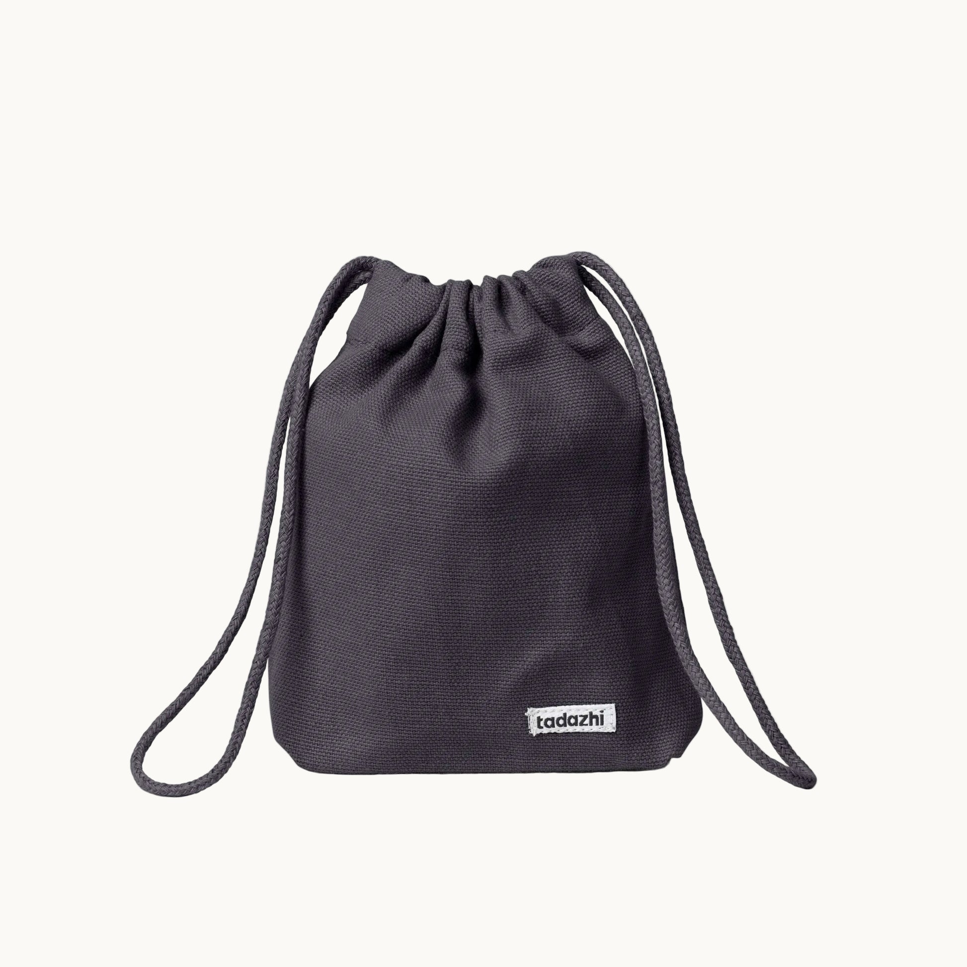 Minimalist dog treat bag in warm grey fabric with drawstring closure, part of Tadazhi x Lumi Pets Walk collection