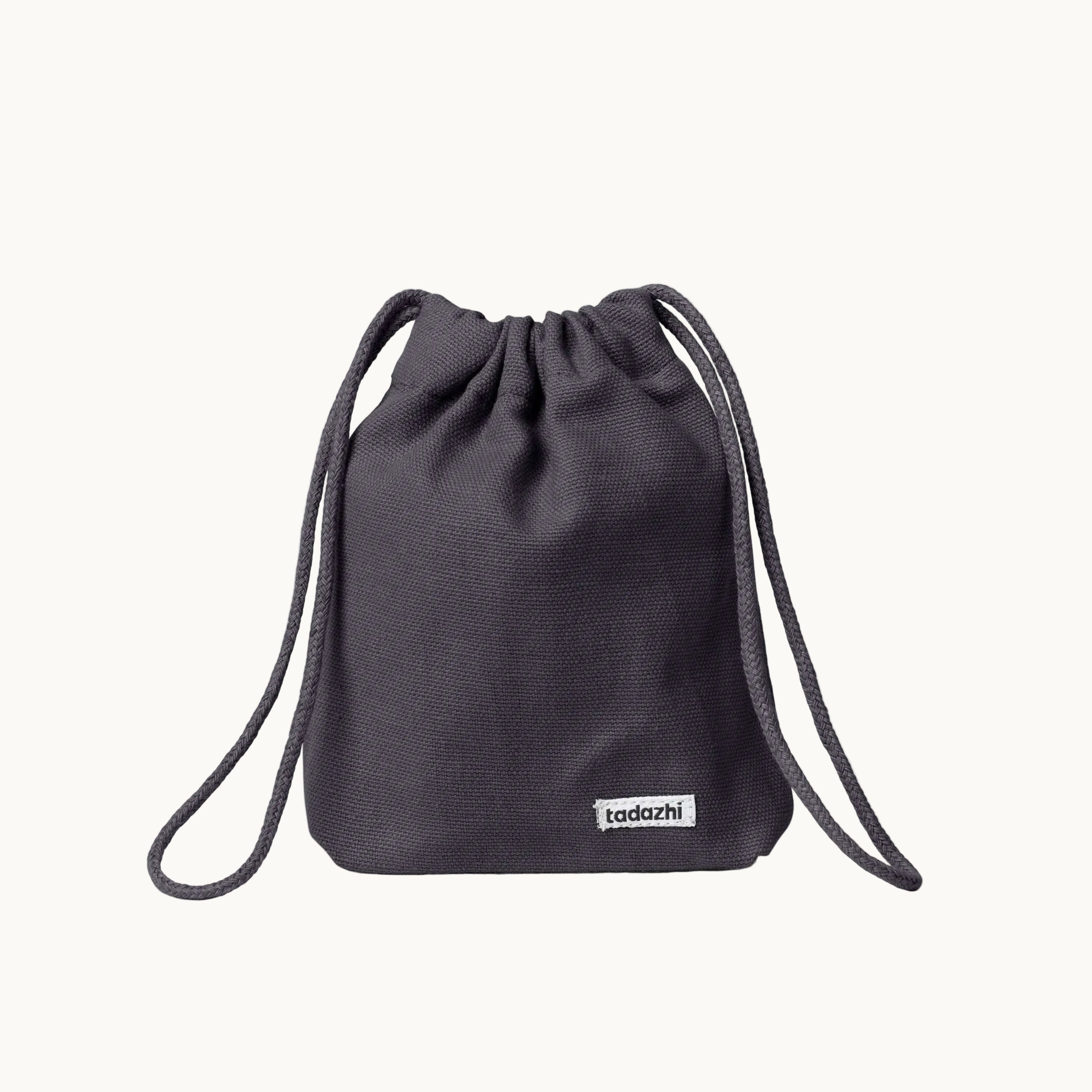 Minimalist dog treat bag in warm grey fabric with drawstring closure, part of Tadazhi x Lumi Pets Walk collection