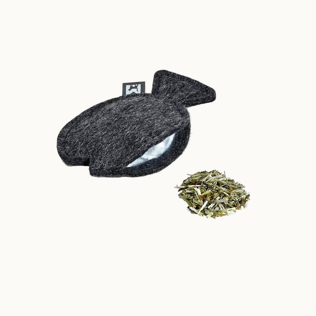 Close-up of MiaCara grey felt catnip toy in fish shape, showing stitching and refillable pouch tag.