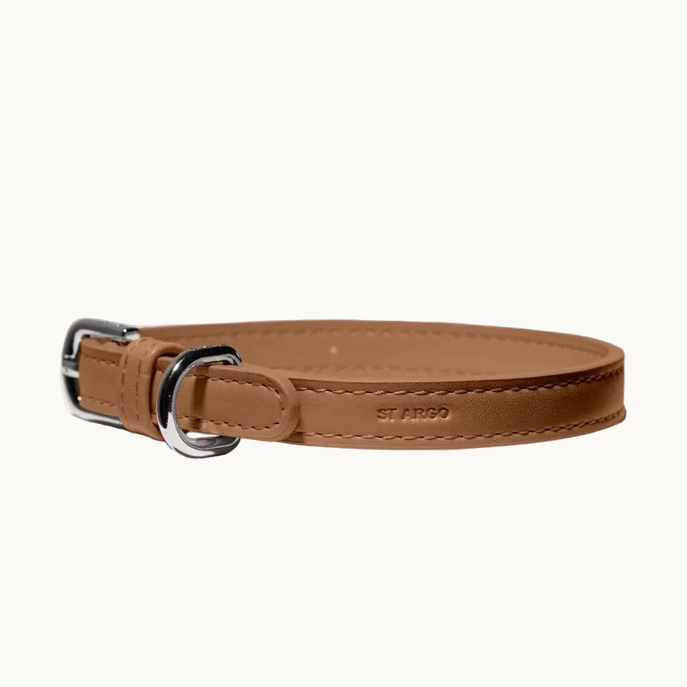 Close-up of vegan leather dog collar in brown, showing smooth finish, stitching, and silver buckle