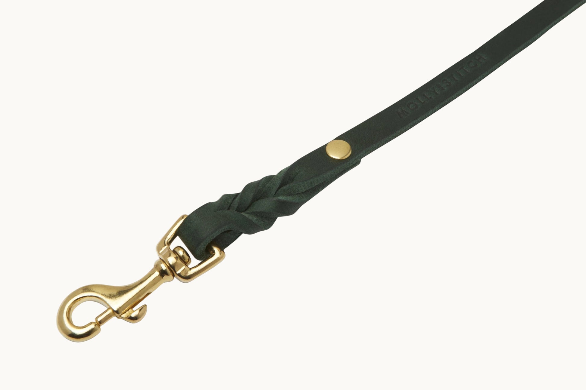 Close-up of Molly & Stitch green butter leather leash, highlighting braided detail and polished gold clasp