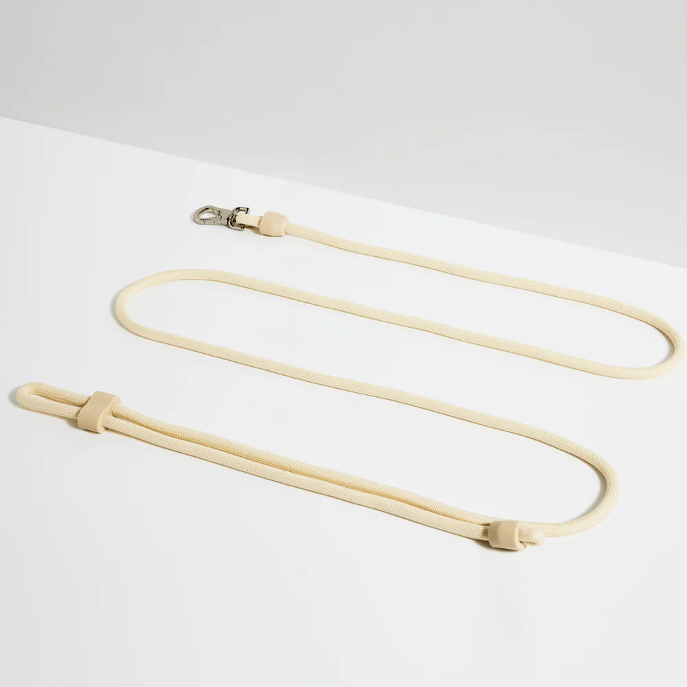 Cream-colored hands-free dog lead with 3-in-1 design, adjustable silicone slider and silver clasp, versatile leash from Lumi Pets Walk collection