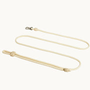 Cream-colored hands-free dog lead with 3-in-1 design, adjustable silicone slider and silver clasp, versatile leash from Lumi Pets Walk collection