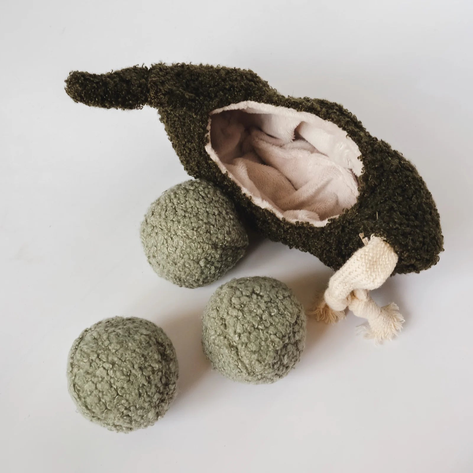 Lambwolf Collective Pea Pop interactive dog toy with plush pea pod and three removable textured green balls, designed for hide-and-seek play
