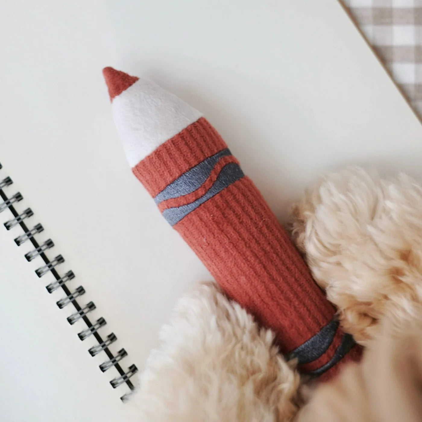 Close-up of Lambwolf Collective Crayons plush toy, textured corduroy fabric crayons with embroidered details.