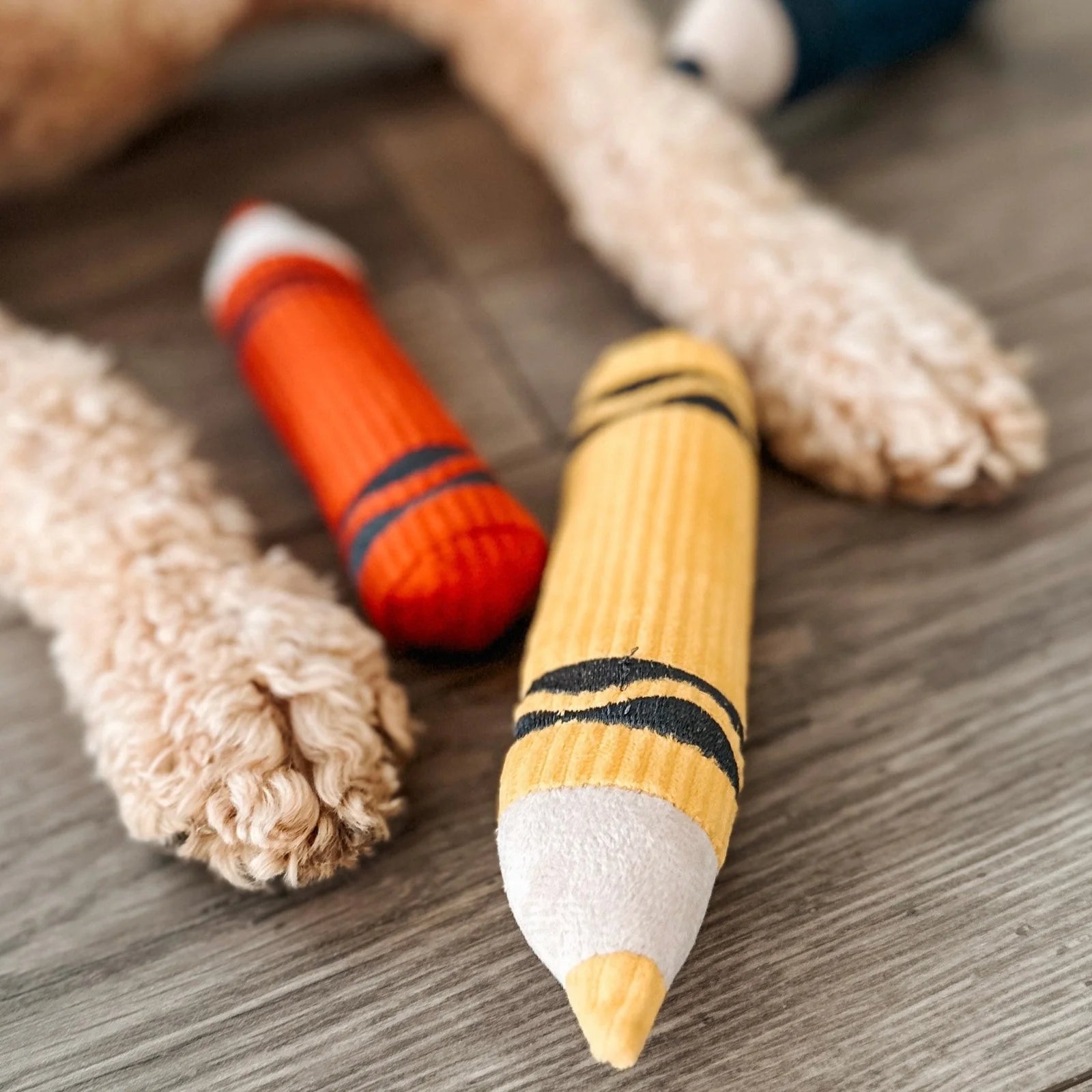 Close-up of Lambwolf Collective Crayons plush toy, textured corduroy fabric crayons with embroidered details.
