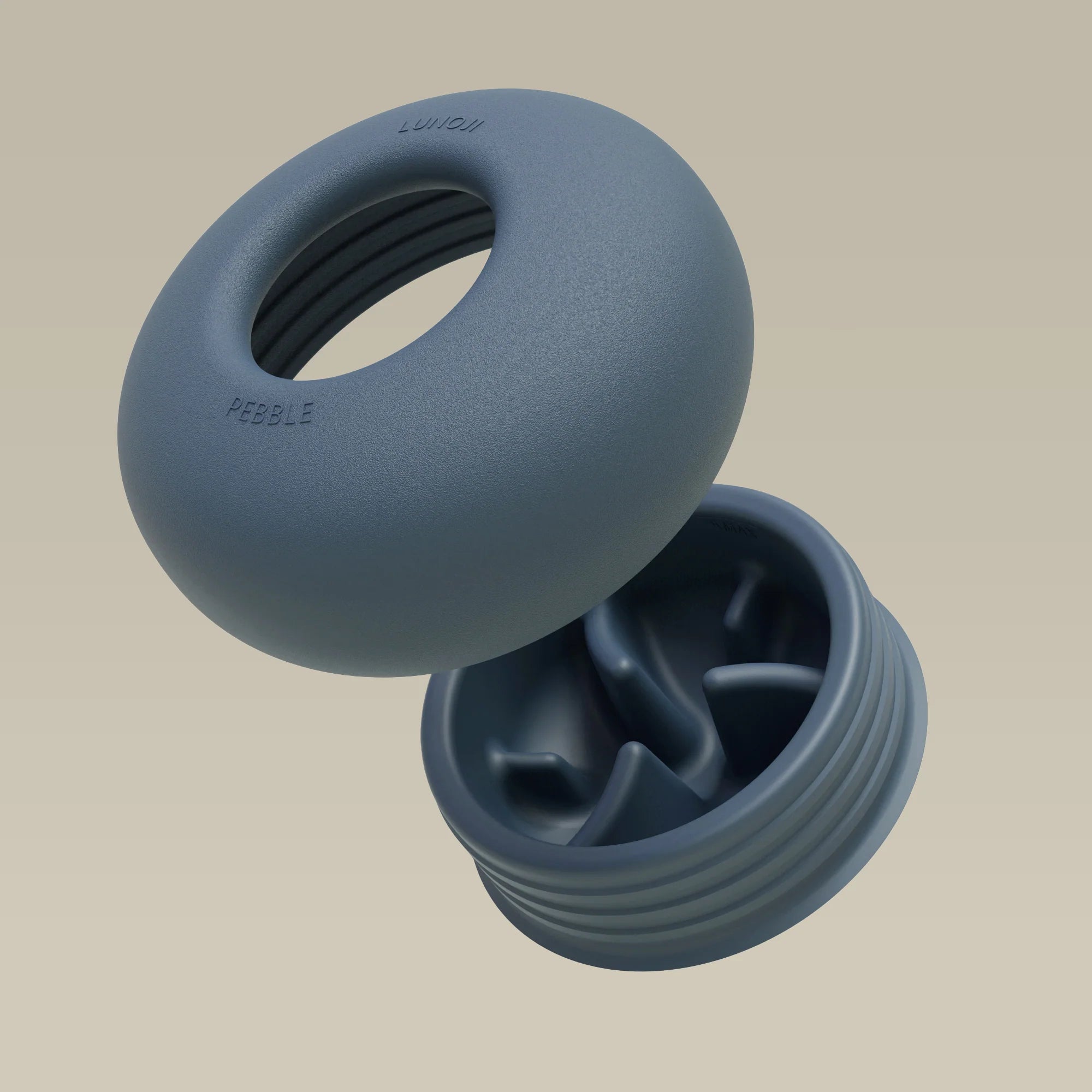 Close-up of opened Lunoji Pebble interactive dog toy in blue showing treat-dispensing hole and smooth silicone finish