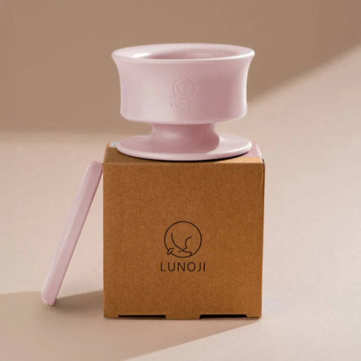 Lunoji Trove slow feeder in pink placed on branded kraft box, minimalist elevated design made from food-grade silicone for enrichment feeding