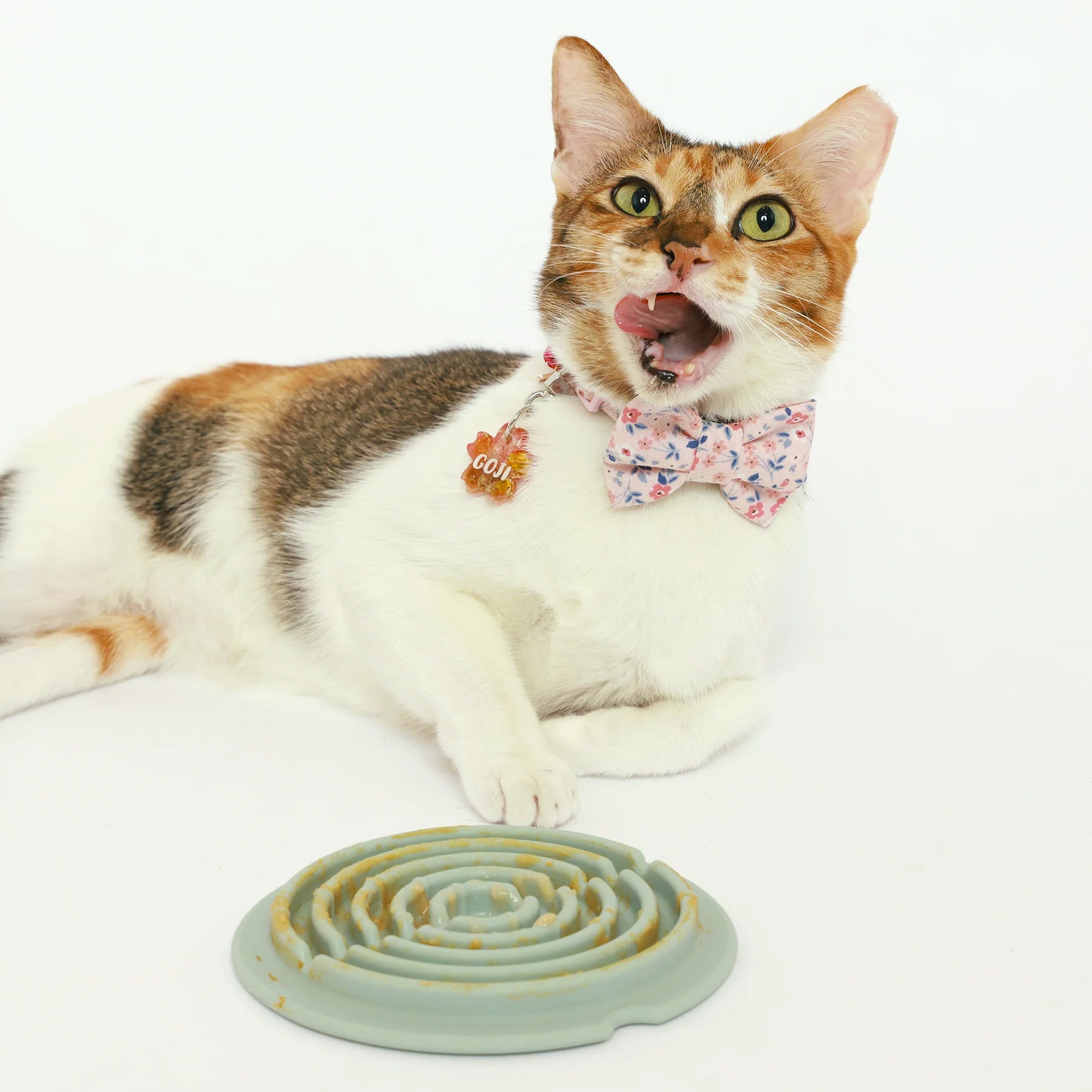 cat licking treats from Lunoji Twirl lick mat, spiral grooves promote slower eating and sensory engagement